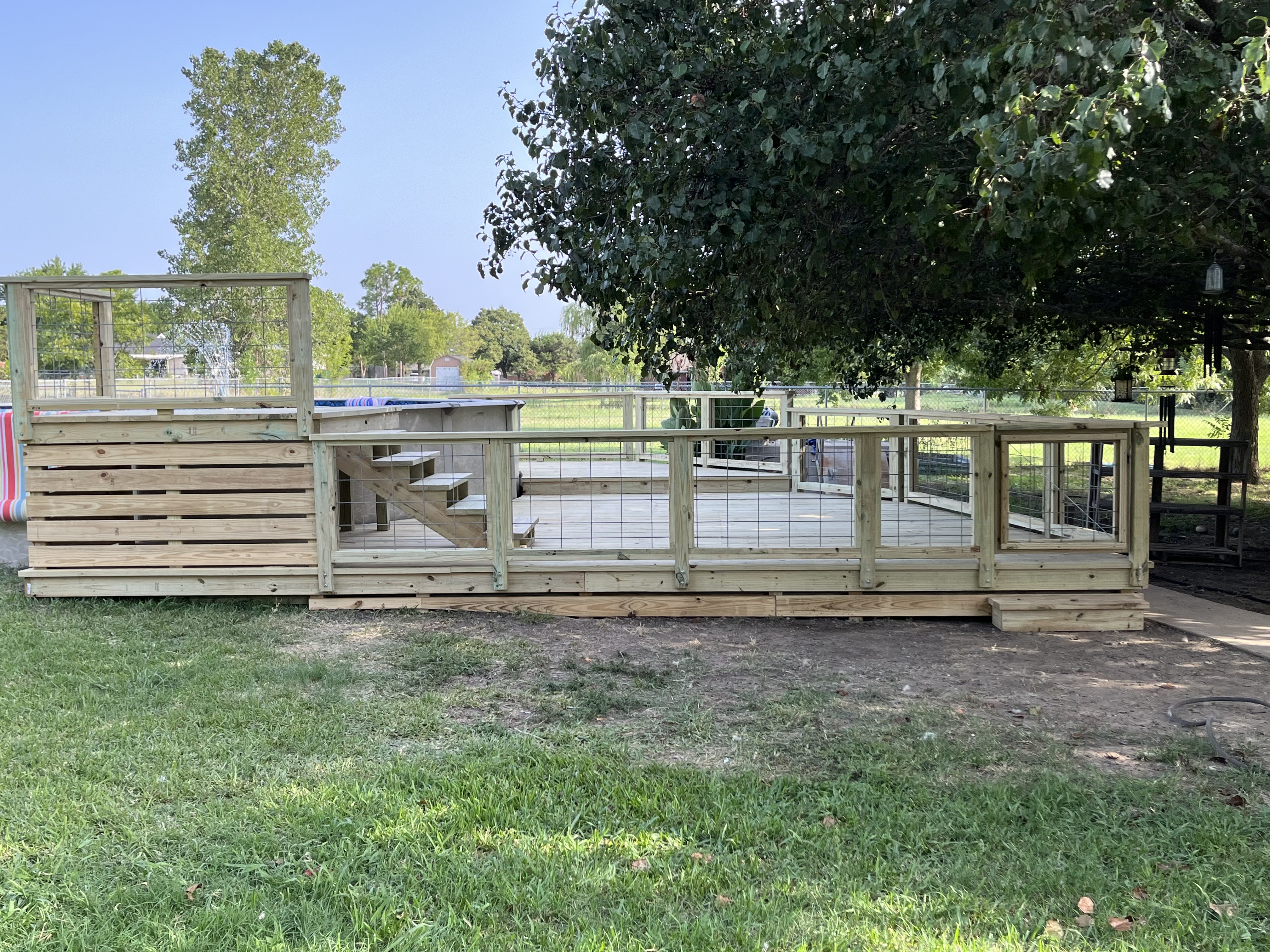 Custom wood pool deck with cattle-panel railing