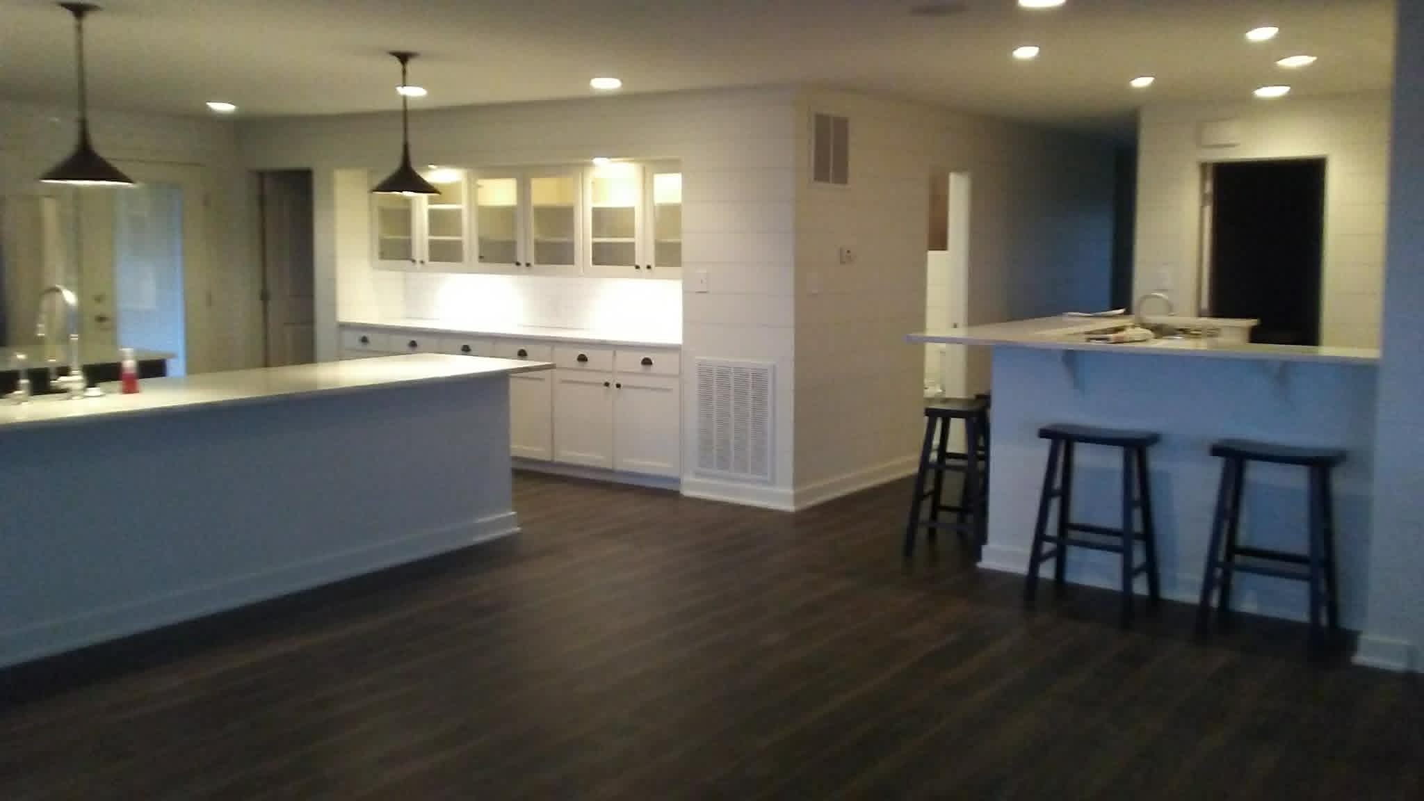 Open concept kitchen with bar seating and dark floors